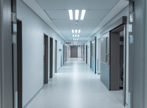 Empty corridor with overhead lighting